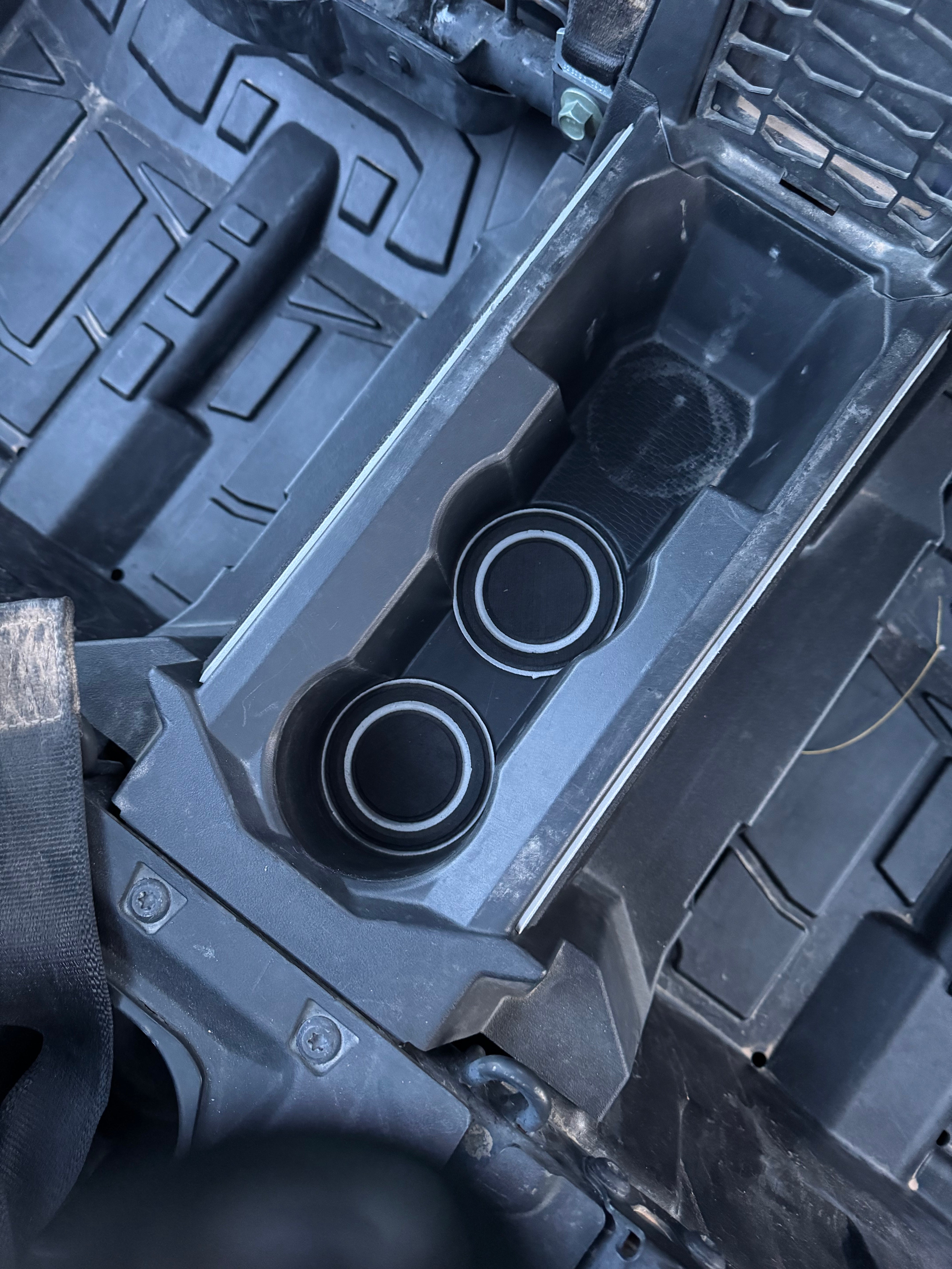 Innovative cup holder inserts with integrated custom foam, delivering enhanced protection, modern style, and a comfortable fit for vehicle interiors.
